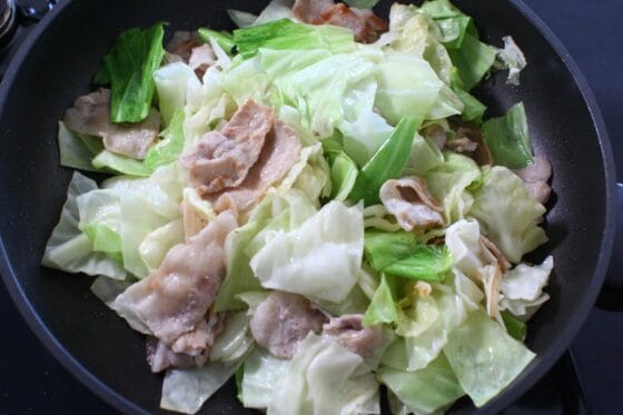 炒めた豚バラとキャベツに塩こしょうを振って、酢と醤油を混ぜたものをフライパンのフチから回し入れる