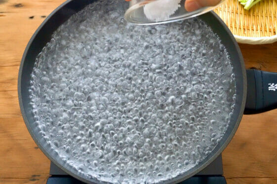フライパンに沸かした湯に塩を加える
