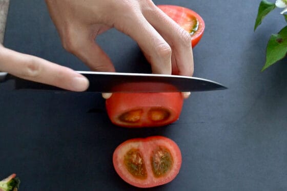 半分に切ったトマトを輪切りにする