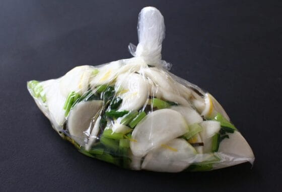 塩漬けしたかぶと葉に昆布と柚子を加えて袋を閉じて置く