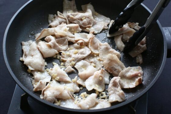 豚肉をフライパンに加えて炒める
