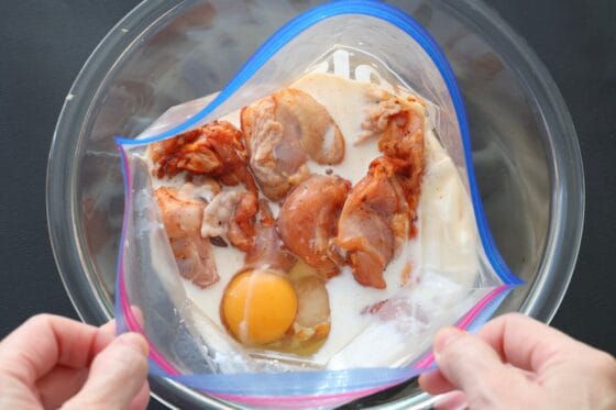 鶏肉が入った袋に牛乳とレモン汁と卵を加える