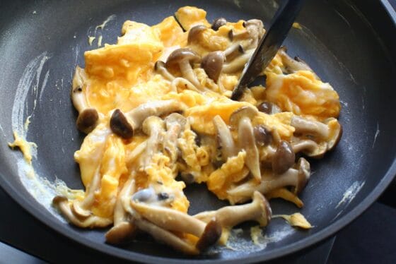 炒めたしめじに卵を回しかけて半熟に固める