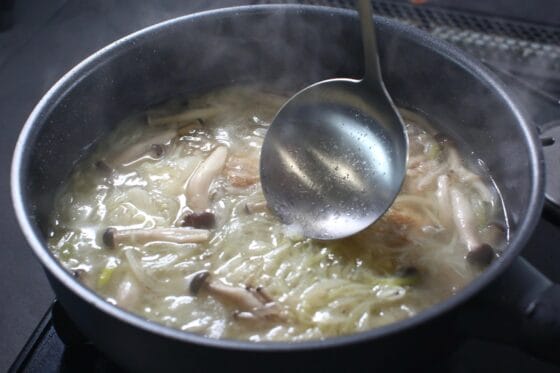 玉ねぎとしめじを煮てアクを取る