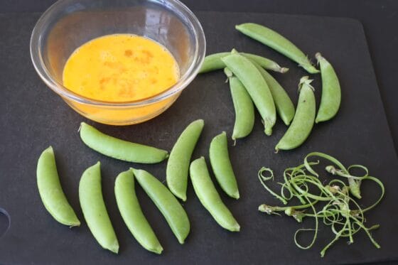卵を溶いてスナップエンドウを準備する