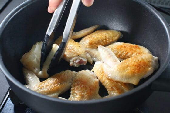 手羽先の余分な脂をキッチンペーパーで拭き取る