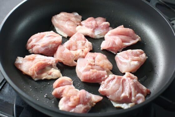 鶏もも肉の皮目を下にしてフライパンで焼く