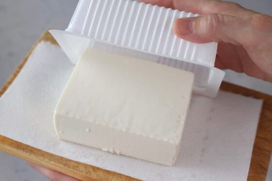 絹ごし豆腐をパックからキッチンペーパーに取り出す