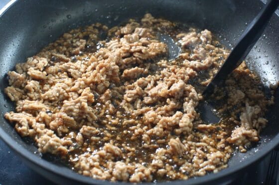 炒めた豚ひき肉に合わせ調味料を加え、中火で全体に絡める
